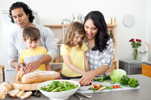 Positive family preparing lunch together in the kitchen
