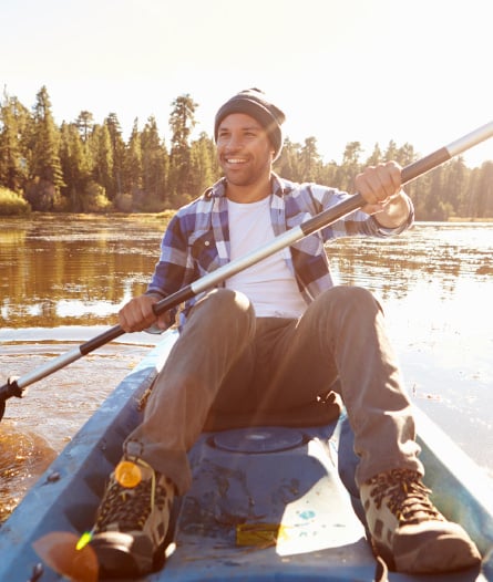 a man kayaking on a lake