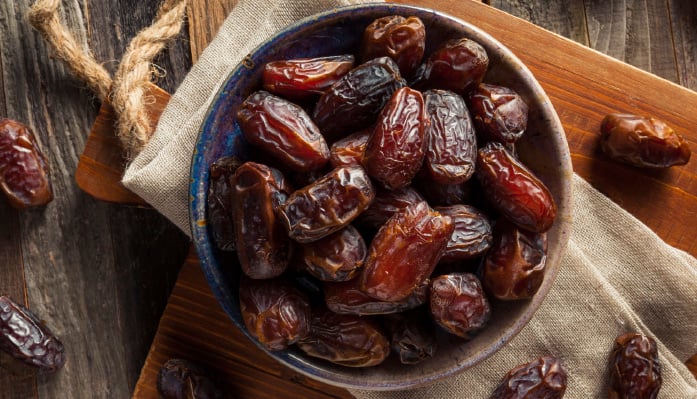 bowl of dates on a cutting board